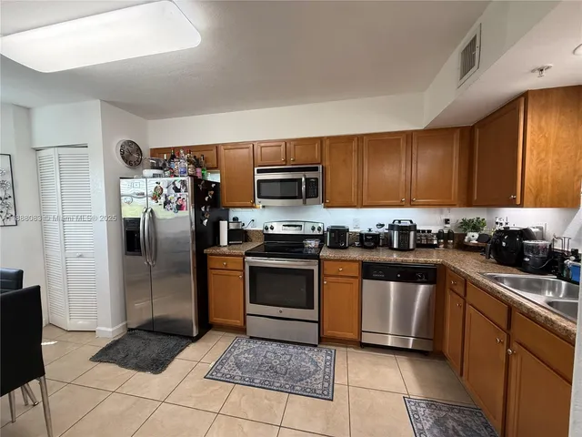 a view of a livingroom with furniture and a flat screen tv