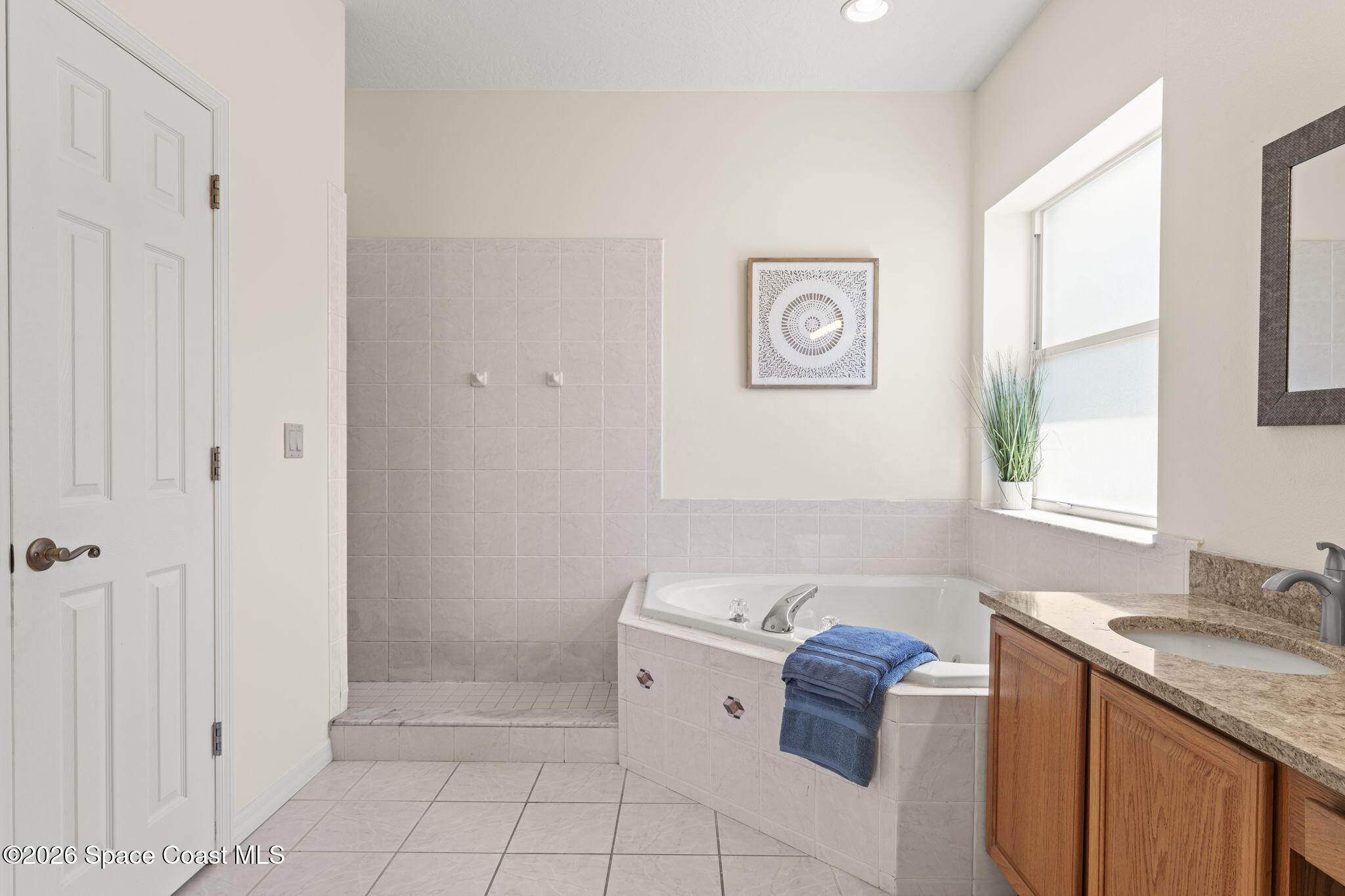 1123 Spring Oak Drive Melbourne, FL 32901 - Photo 37 of 67 a bathroom with a sink a vanity and a mirror