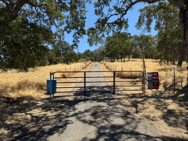 a view of a wooden fence and trees