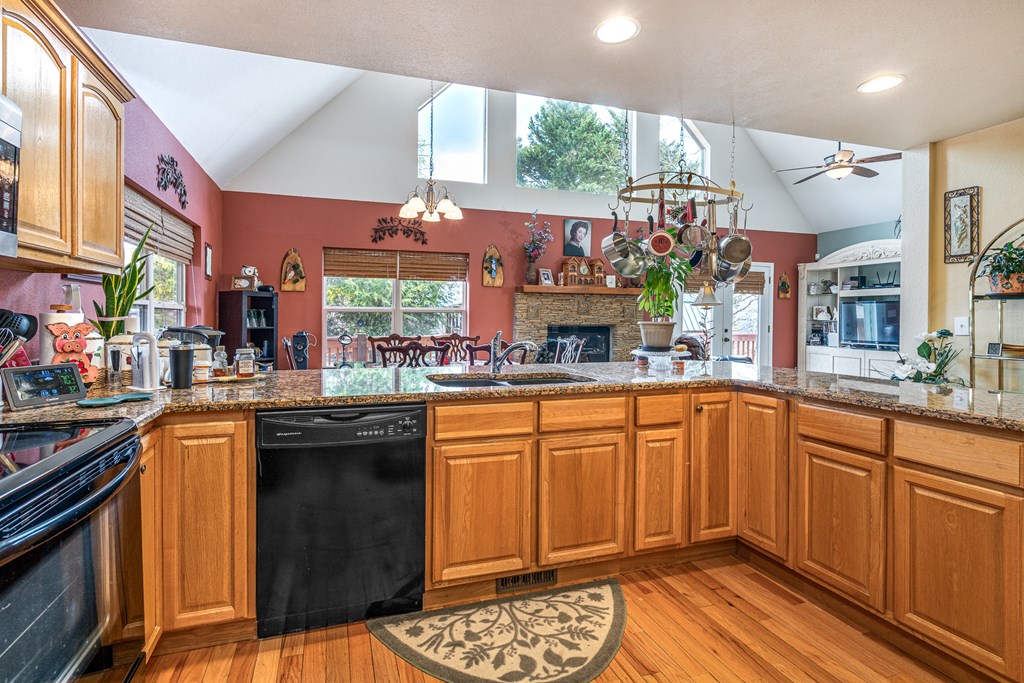 210 Pin Oak Ridge Murphy, NC 28906 - Photo 7 of 51 a kitchen with stainless steel appliances granite countertop a sink and wooden cabinets