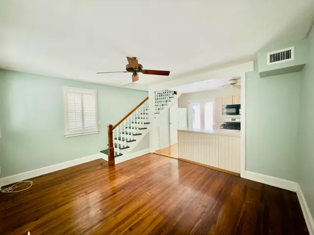 a view of entryway and hall with wooden floor