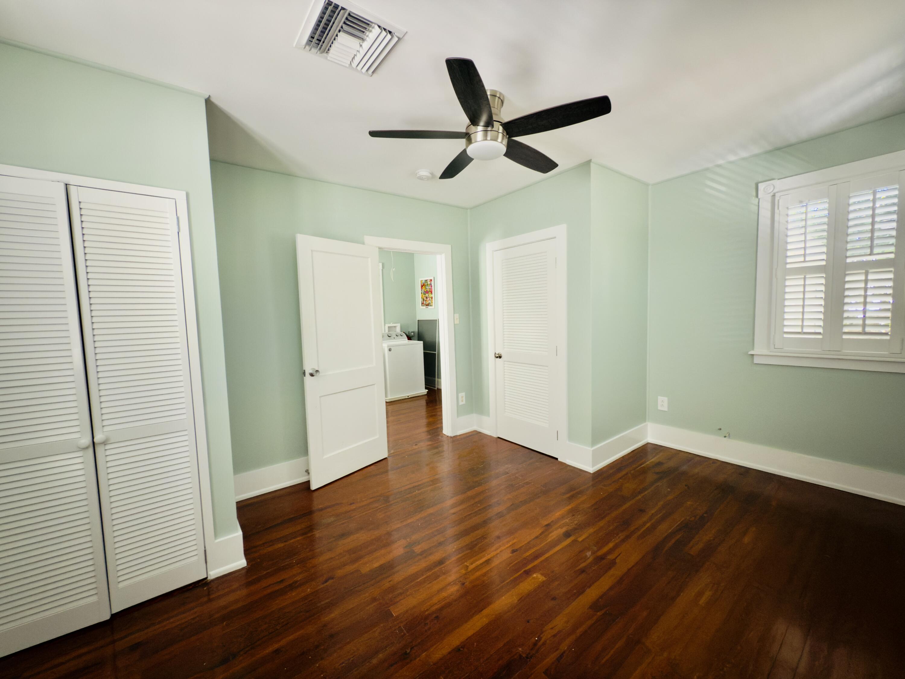 728 Ashe Street Key West, FL 33040 - Photo 15 of 25 an empty room with wooden floor and windows