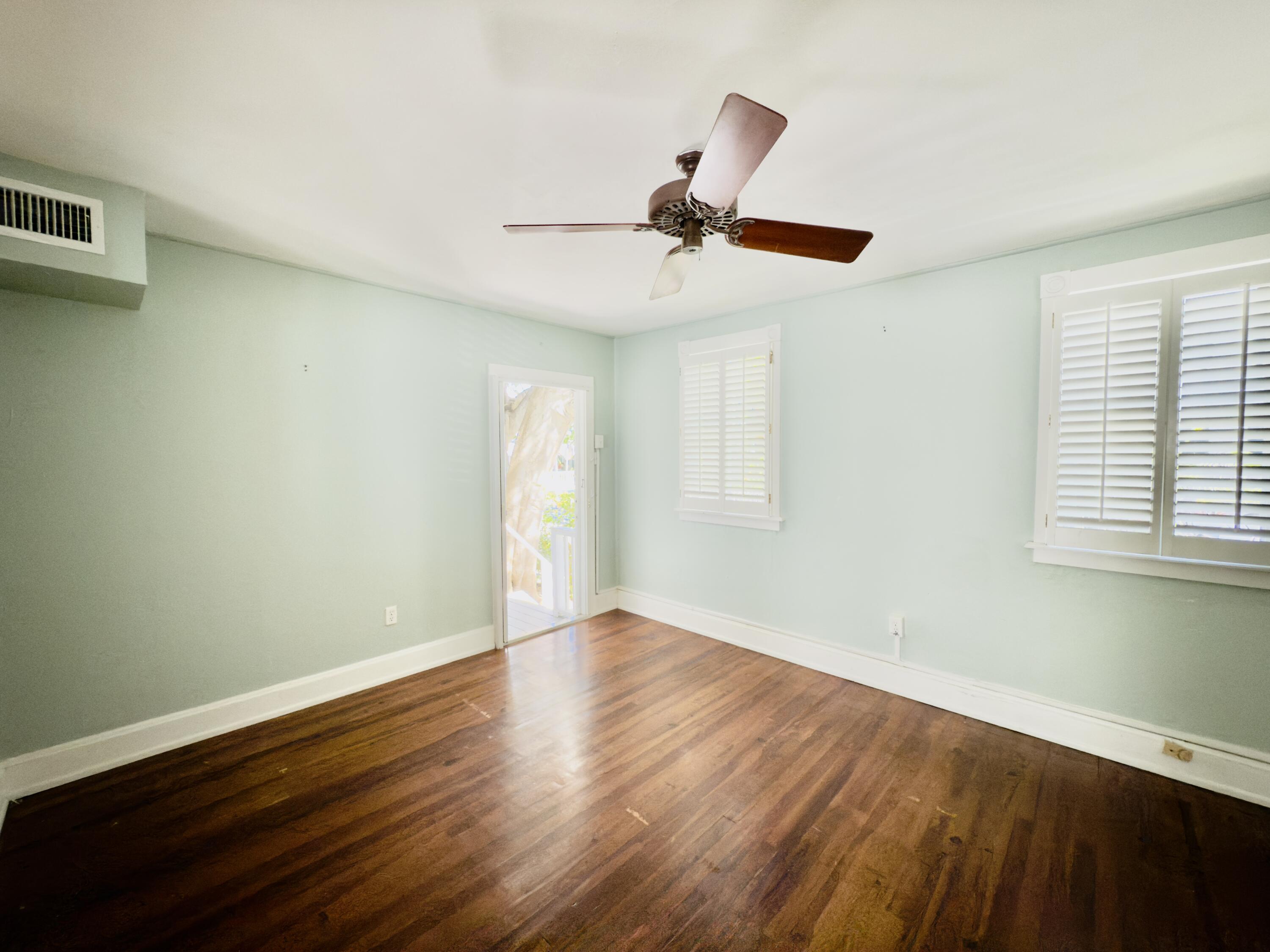 728 Ashe Street Key West, FL 33040 - Photo 2 of 25 a view of an empty room with wooden floor and a window