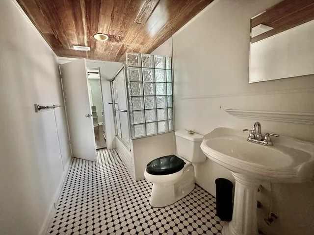 a bathroom with a sink toilet and shower