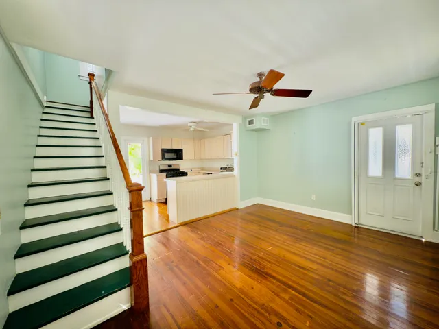 a view of entryway and hall with wooden floor