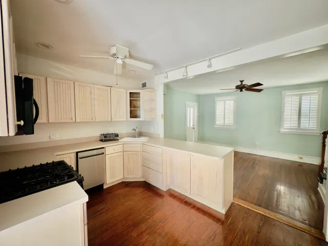 a kitchen with a sink a stove and cabinets