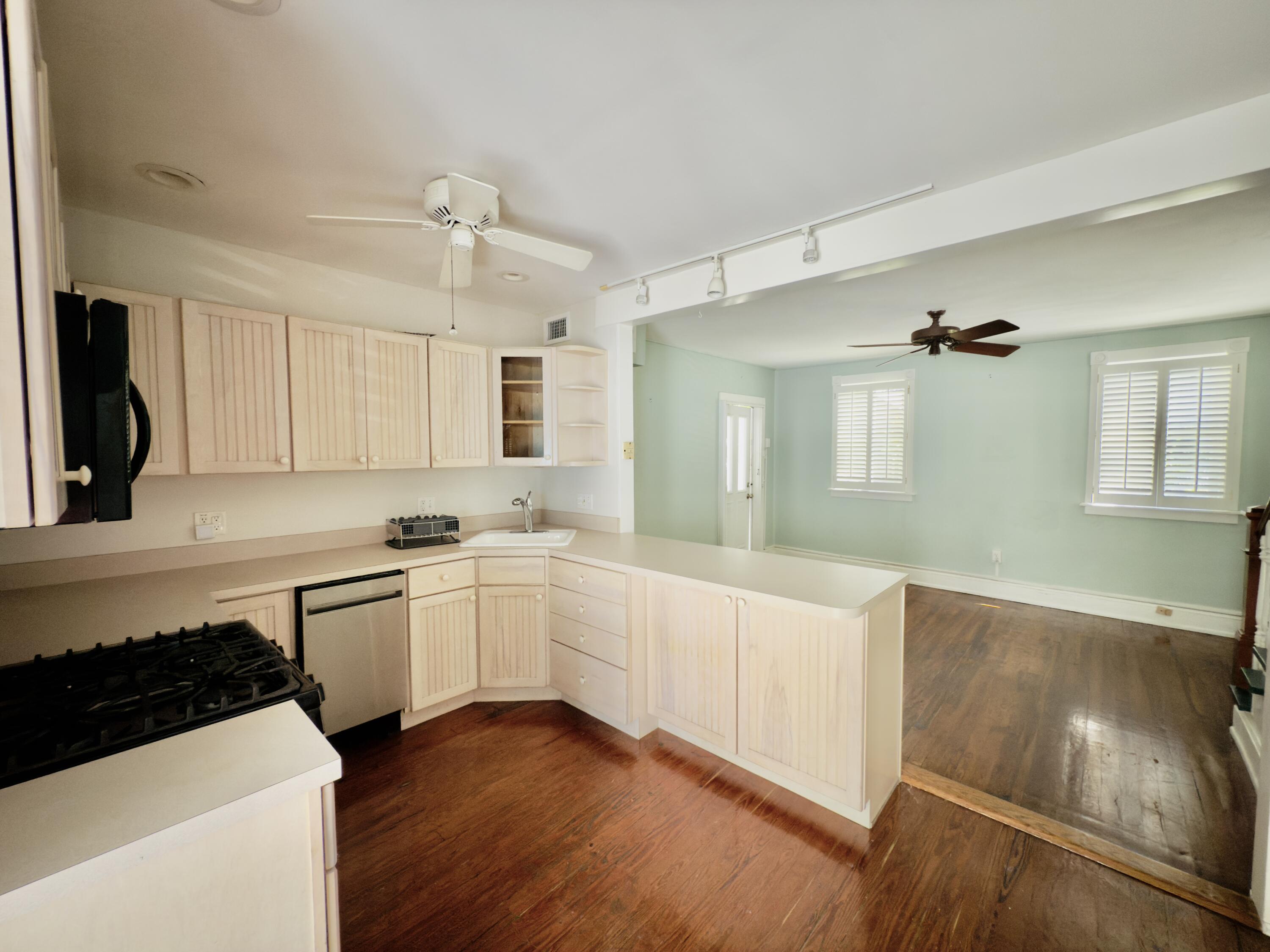 728 Ashe Street Key West, FL 33040 - Photo 5 of 25 a kitchen with a sink a stove and cabinets