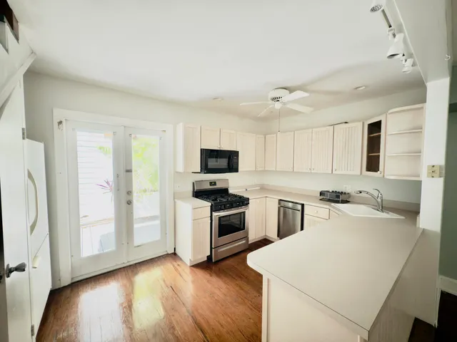 a kitchen with stove cabinets and refrigerator
