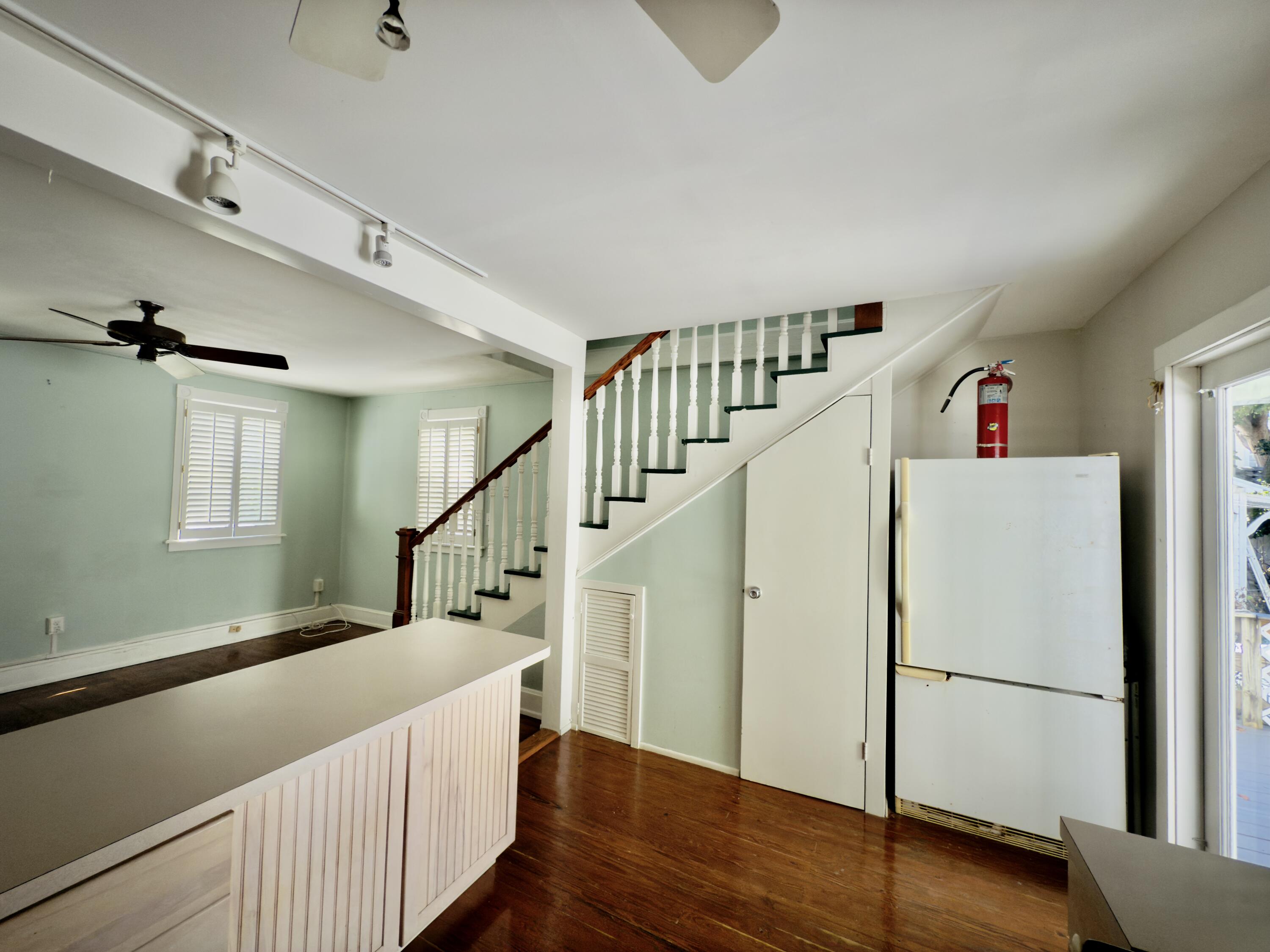 728 Ashe Street Key West, FL 33040 - Photo 7 of 25 a view of a hallway with wooden floor and stairs