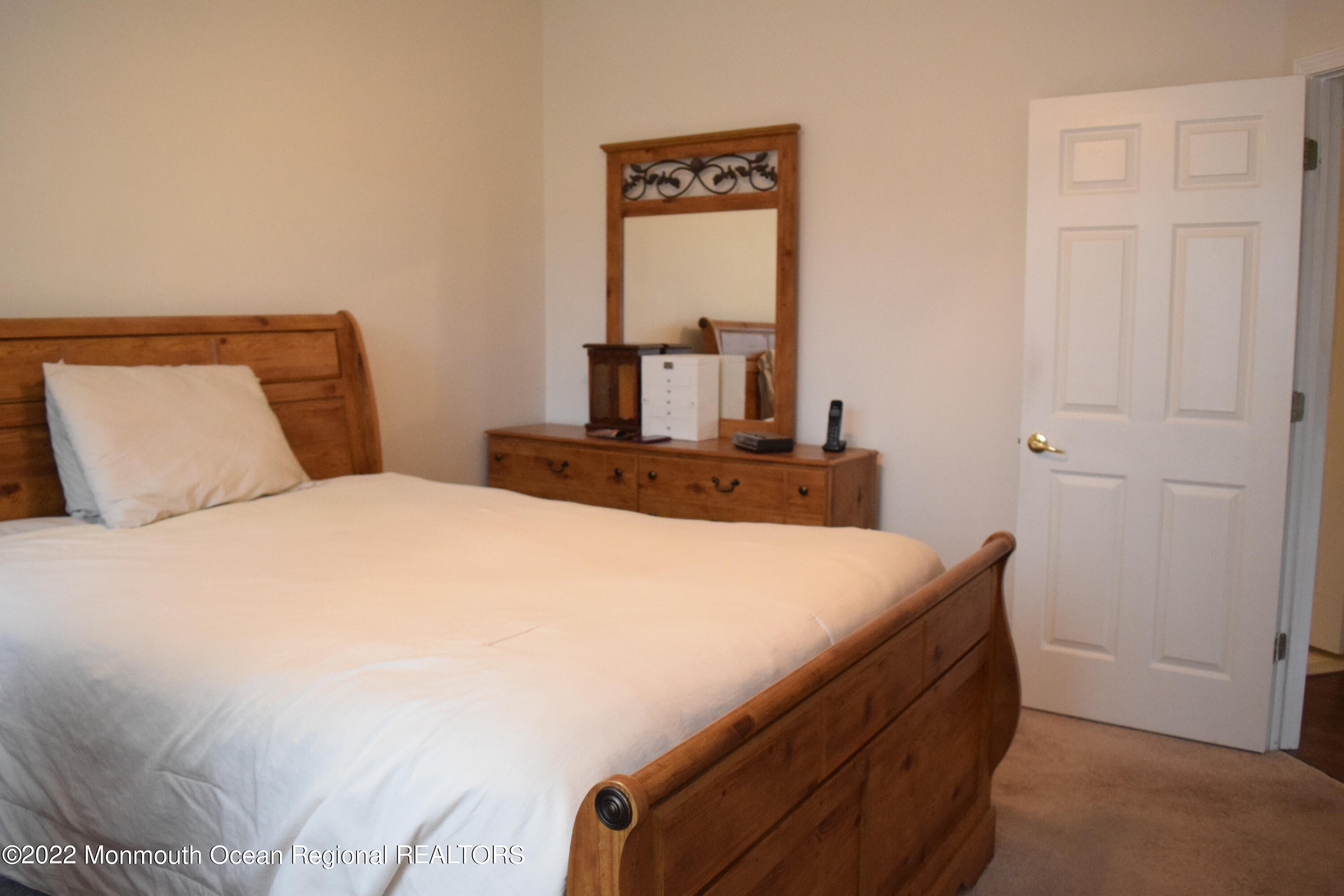 23 Foxwood Road Lakewood, NJ 08701 - Photo 13 of 34 a bedroom with a bed and a mirror