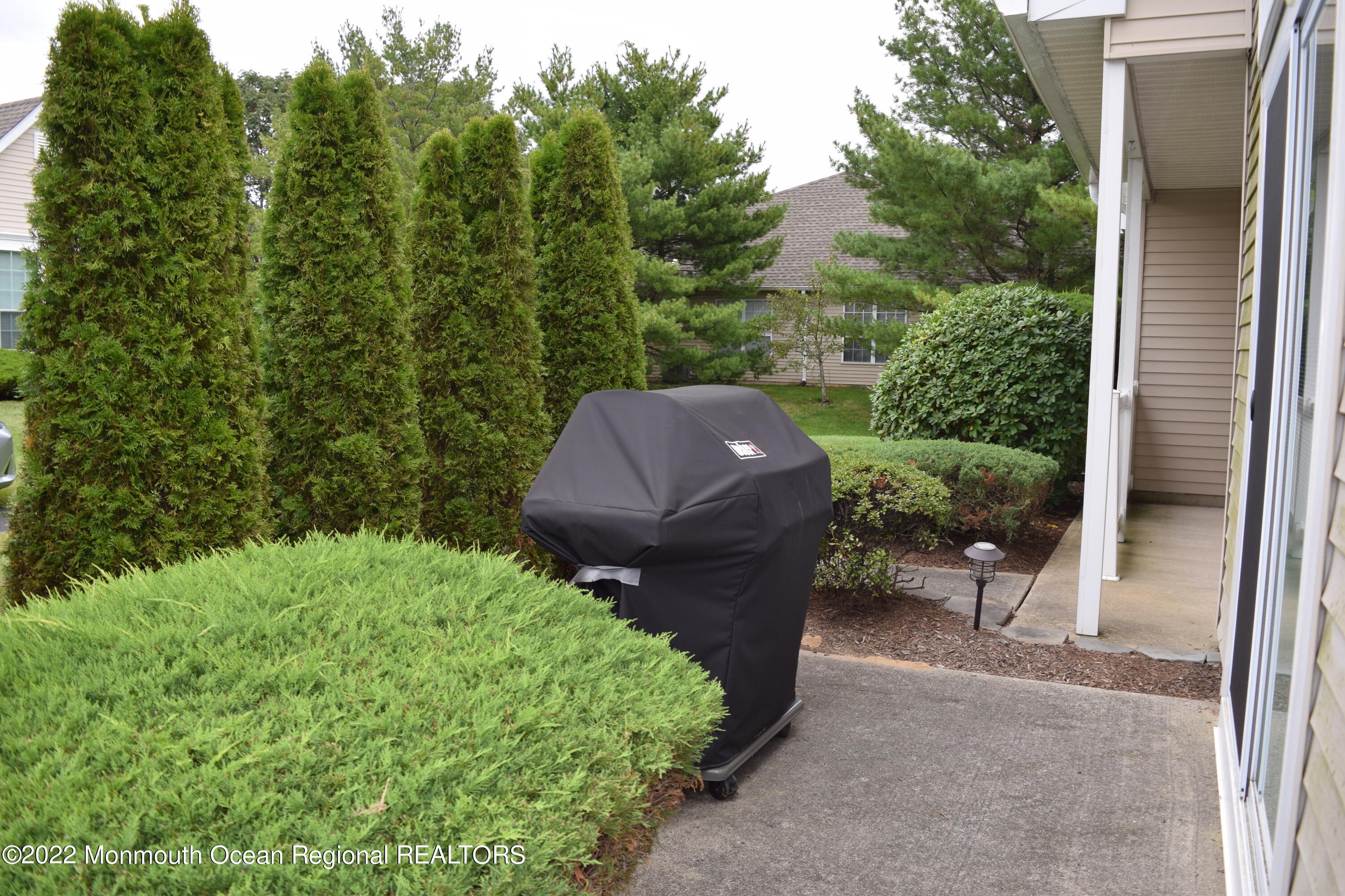 23 Foxwood Road Lakewood, NJ 08701 - Photo 26 of 34 a view of a backyard with plants and a garden