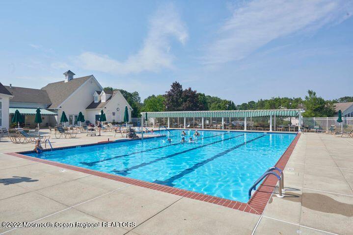 23 Foxwood Road Lakewood, NJ 08701 - Photo 32 of 34 a view of swimming pool with seating area and trees in the background