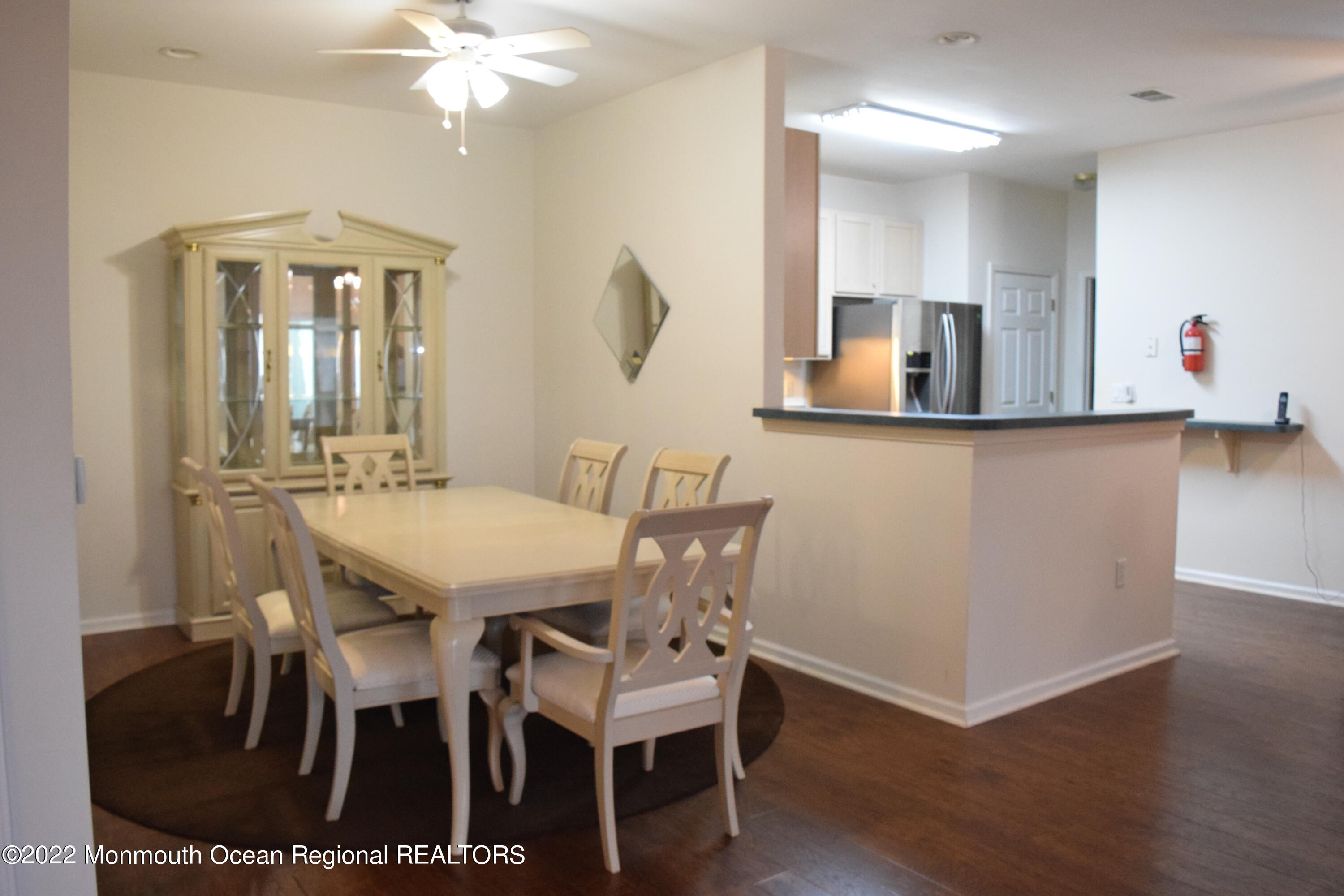 23 Foxwood Road Lakewood, NJ 08701 - Photo 5 of 34 a view of a dining room with furniture and wooden floor