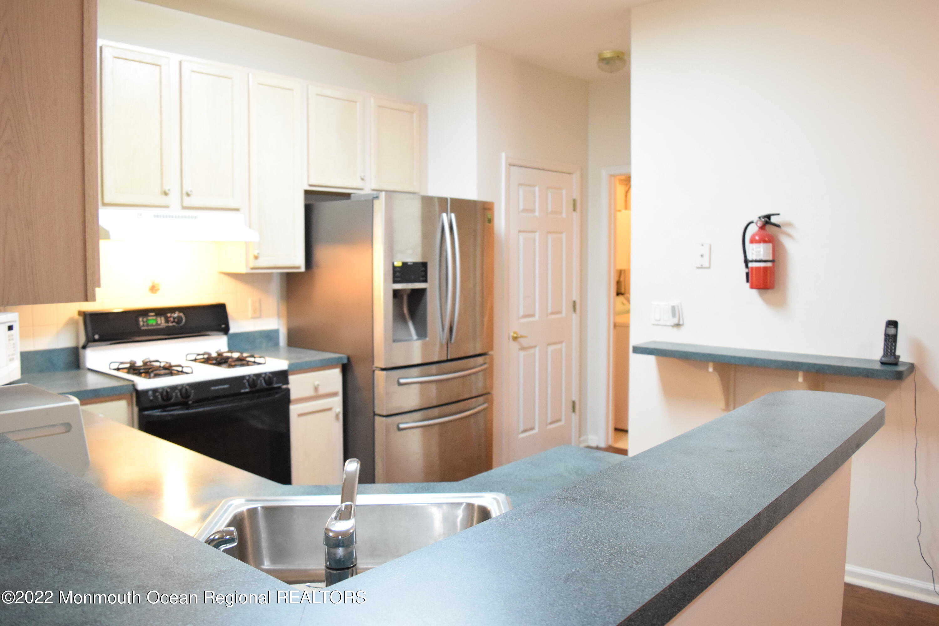 23 Foxwood Road Lakewood, NJ 08701 - Photo 7 of 34 a kitchen with stainless steel appliances granite countertop a refrigerator a stove and a sink with wooden floor