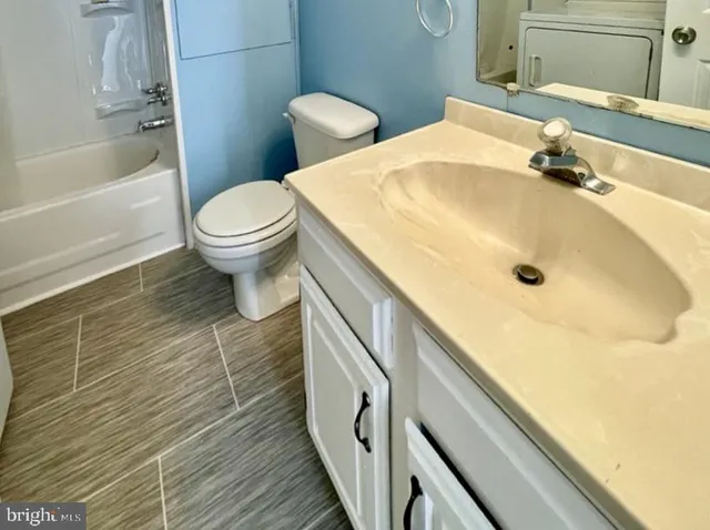 a bathroom with a sink a toilet and bathtub