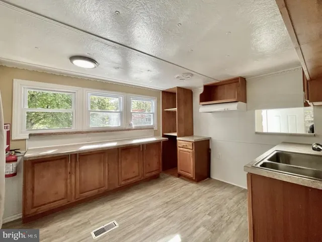 a kitchen with sink and cabinets