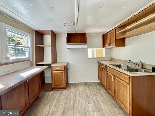 a kitchen with a sink stove top oven and cabinets