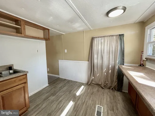 a kitchen with a wooden floor and a stove top oven