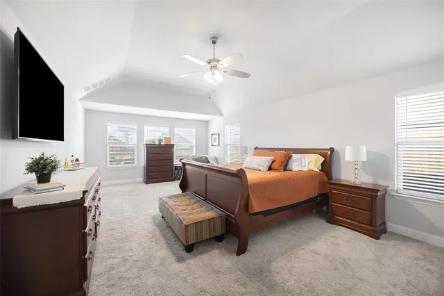 a bedroom with furniture and a flat screen tv