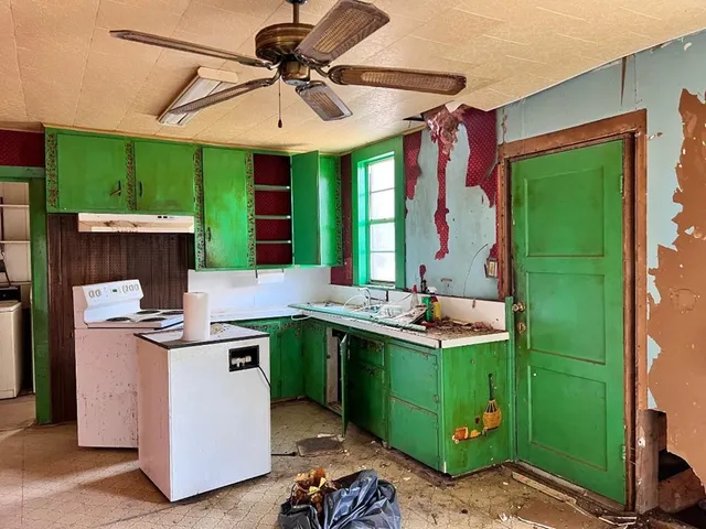 a view of a kitchen with a sink and cabinets