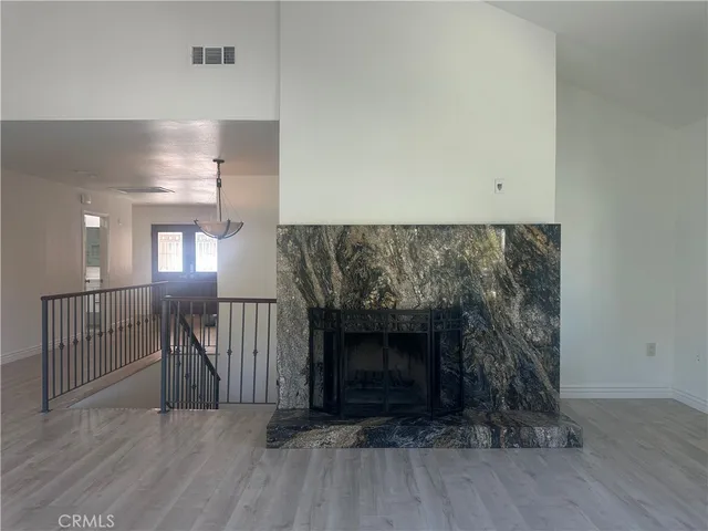 a view of a livingroom with wooden floor a fireplace
