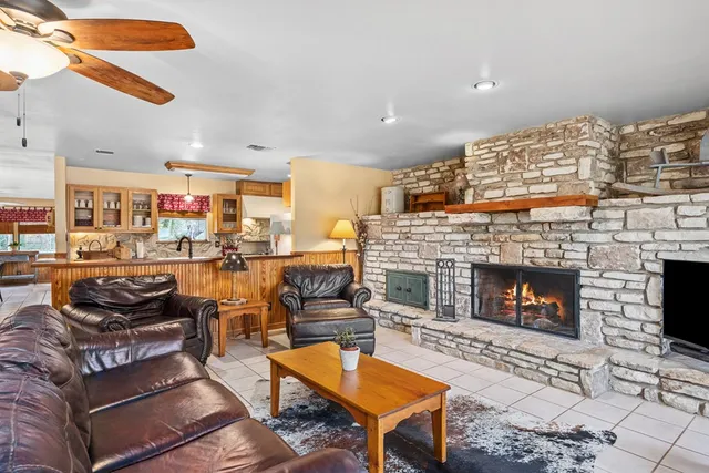 a living room with furniture a fireplace and a table