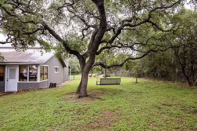 a view of a house with a tree in a yard