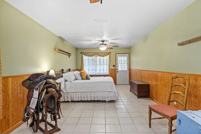 a spacious bedroom with a bed and dresser