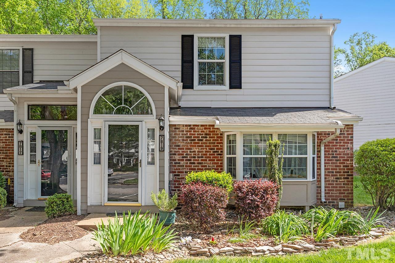 7819 Falcon Rest Circle, Unit END Raleigh, NC 27615 - Photo 1 of 38 a front view of a house with garden
