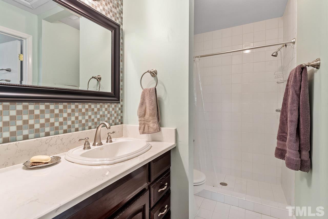 7819 Falcon Rest Circle, Unit END Raleigh, NC 27615 - Photo 36 of 38 a bathroom with a sink and a mirror