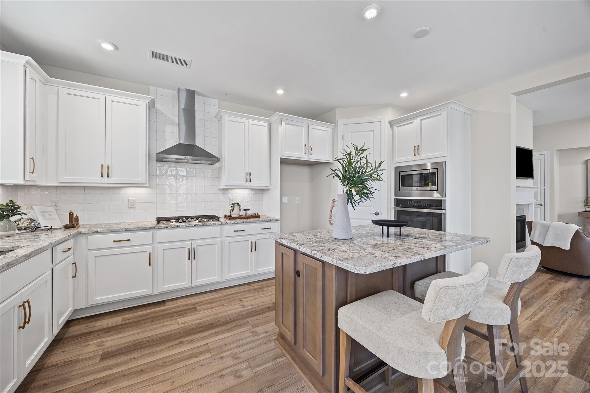 5075 Valita Road York, SC 29745 - Photo 12 of 48 a kitchen with granite countertop white cabinets and stainless steel appliances