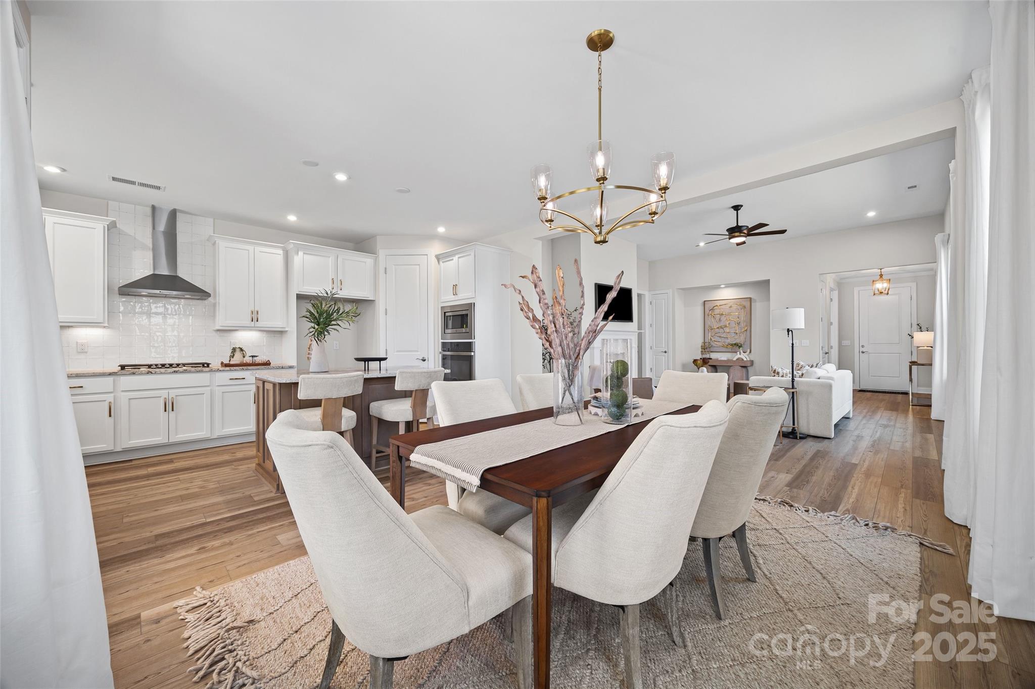 5075 Valita Road York, SC 29745 - Photo 20 of 48 a view of a dining room and livingroom with furniture wooden floor a rug a fireplace