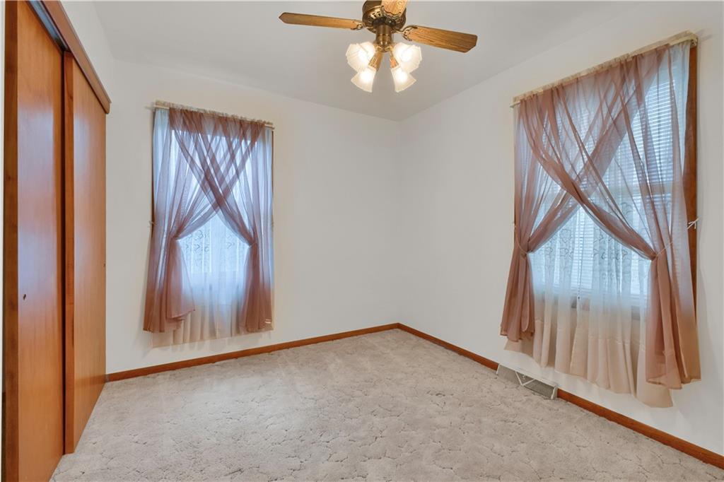 374 Goldsmith Road Pittsburgh, PA 15237 - Photo 15 of 25 an empty room with wooden floor fan and windows