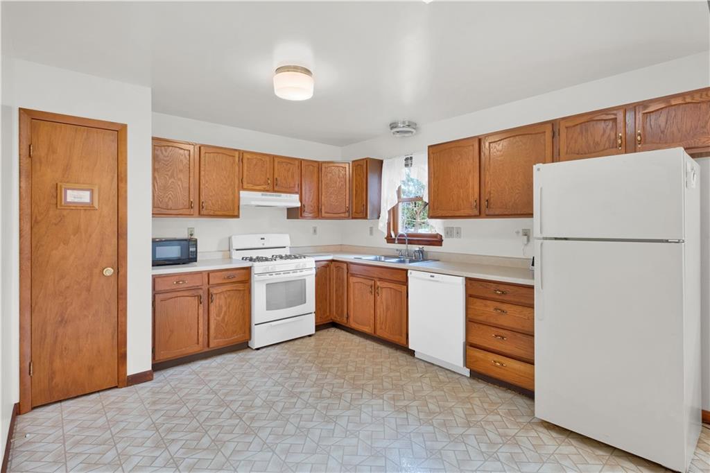374 Goldsmith Road Pittsburgh, PA 15237 - Photo 6 of 25 a kitchen with white cabinets and white appliances
