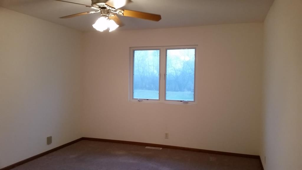 7031 Rye Ridge Trail Cherry Valley, IL 61016 - Photo 9 of 13 an empty room with windows and fan