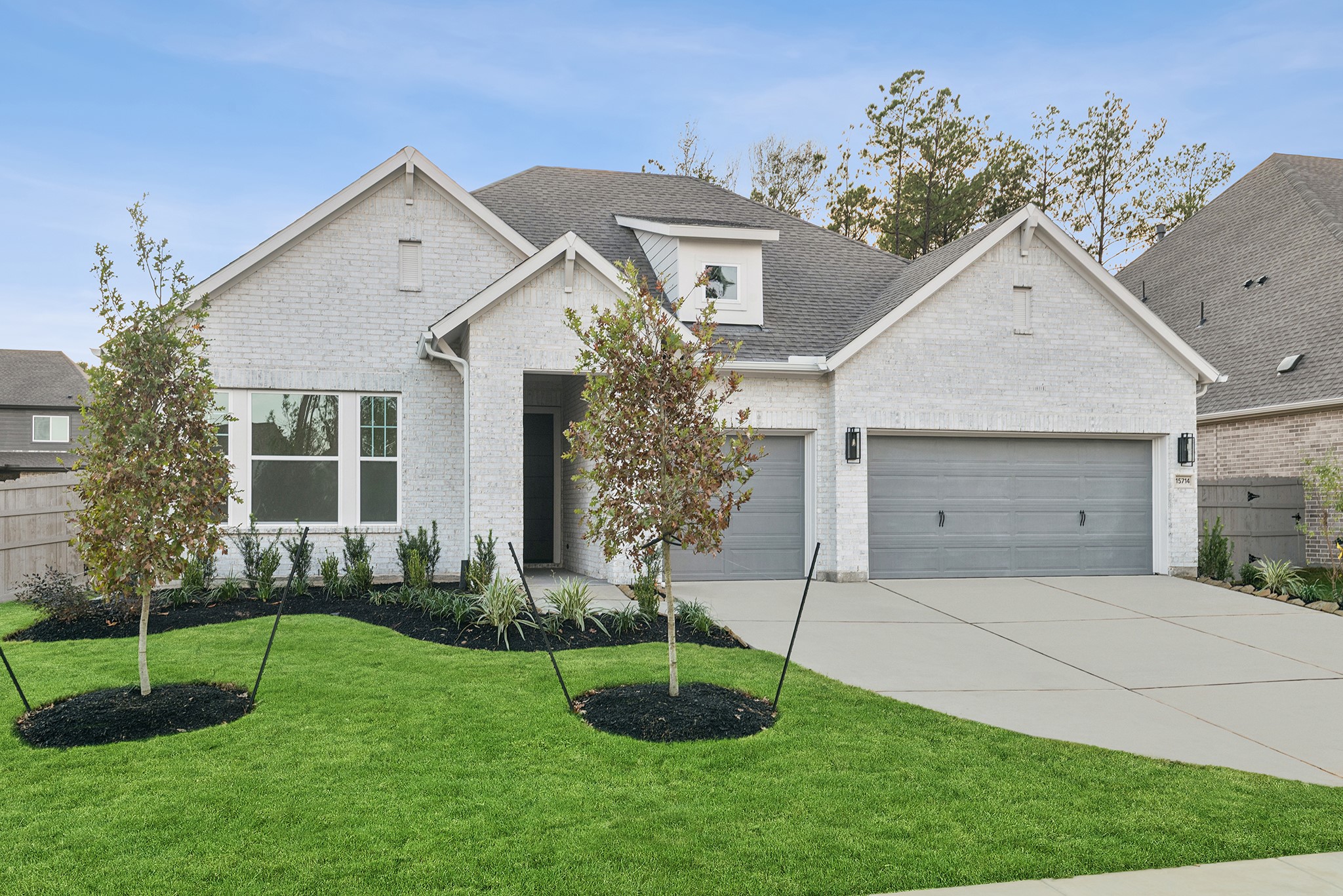 15714 Terracotta Terrace Lane Conroe, TX 77302 - Photo 1 of 47 a front view of a house with a yard and a garage