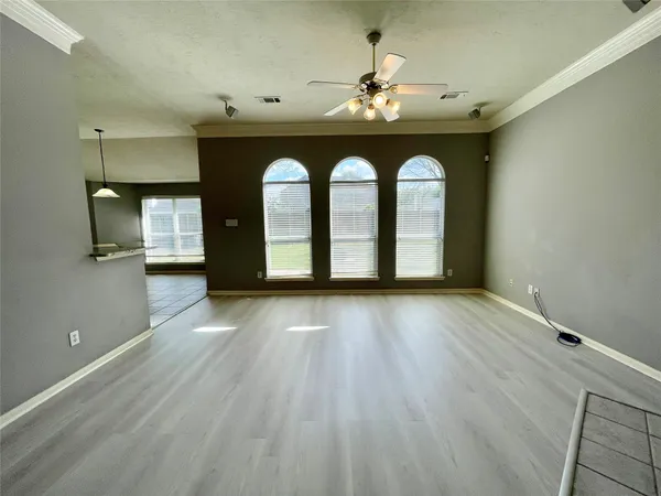 a view of an empty room with a fireplace and a window