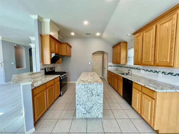 a kitchen with stainless steel appliances granite countertop a sink and a white cabinets