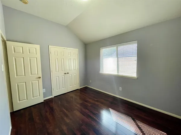 a view of a room with wooden floor and window