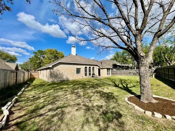 a yellow house with a yard