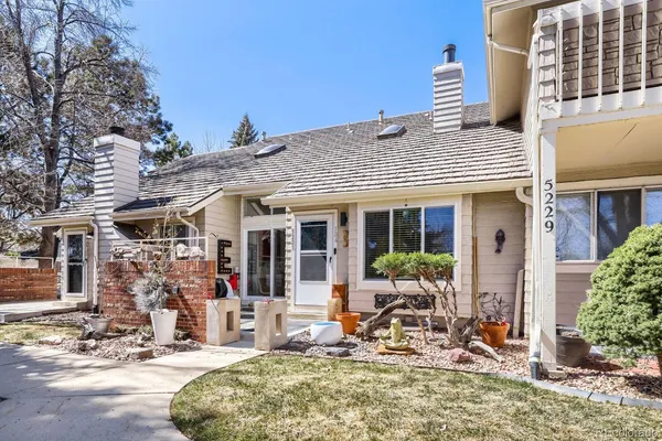 a front view of a house with outdoor seating