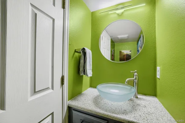 a bathroom with a toilet and a mirror