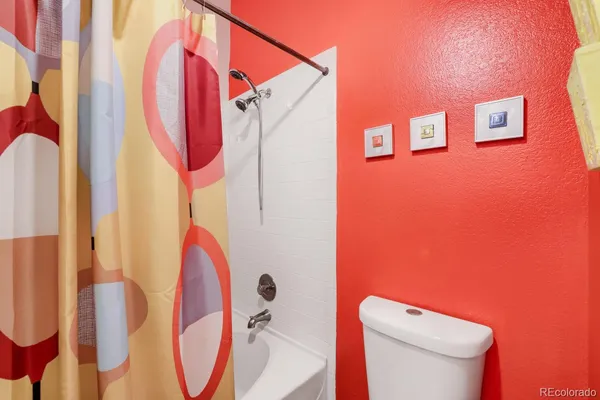 a bathroom with a toilet and shower