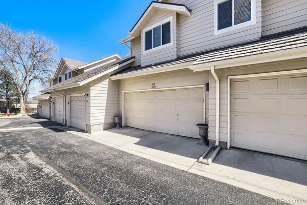 a view of a house with a yard and garage