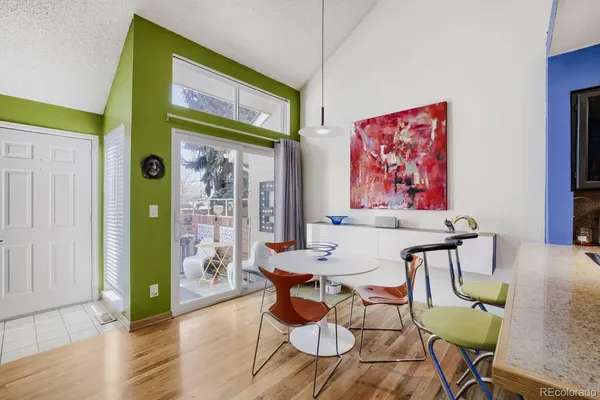 a view of a dining room with furniture a chandelier and wooden floor