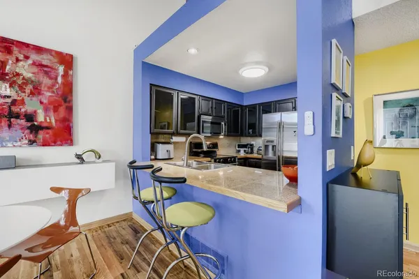 a view of a dining room with furniture and a kitchen