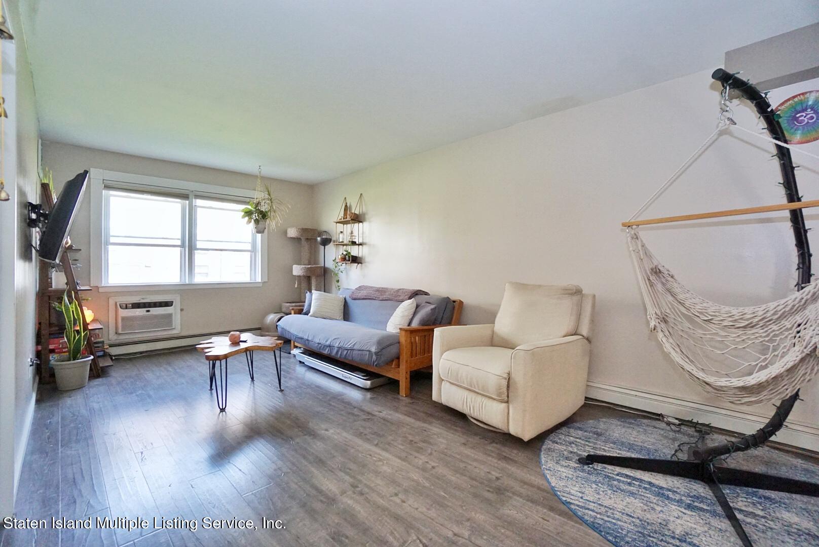 40 Racal Court, Unit B1 Staten Island, NY 10314 - Photo 11 of 16 a living room with furniture and a window