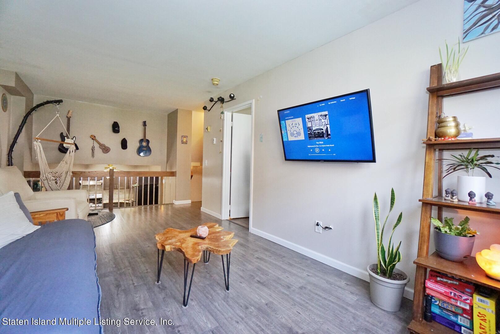 40 Racal Court, Unit B1 Staten Island, NY 10314 - Photo 12 of 16 a living room with furniture and wooden floor