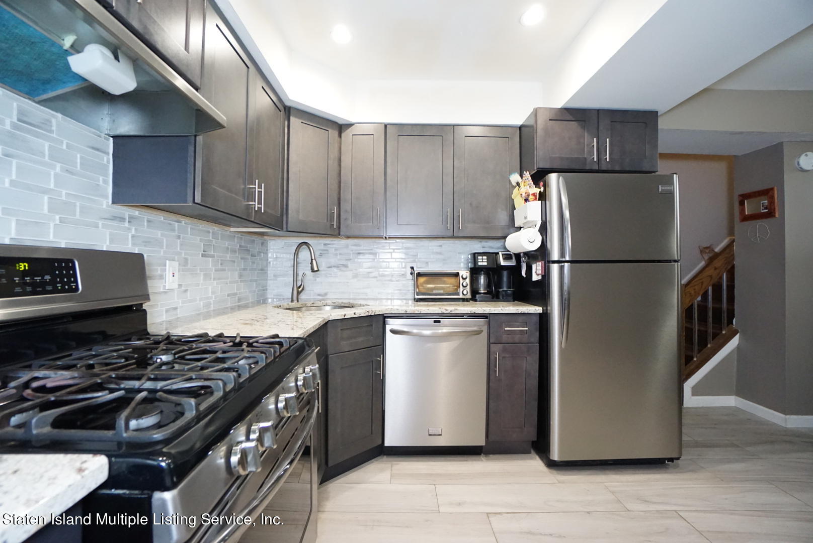 40 Racal Court, Unit B1 Staten Island, NY 10314 - Photo 2 of 16 a kitchen with a refrigerator a stove a sink and cabinets
