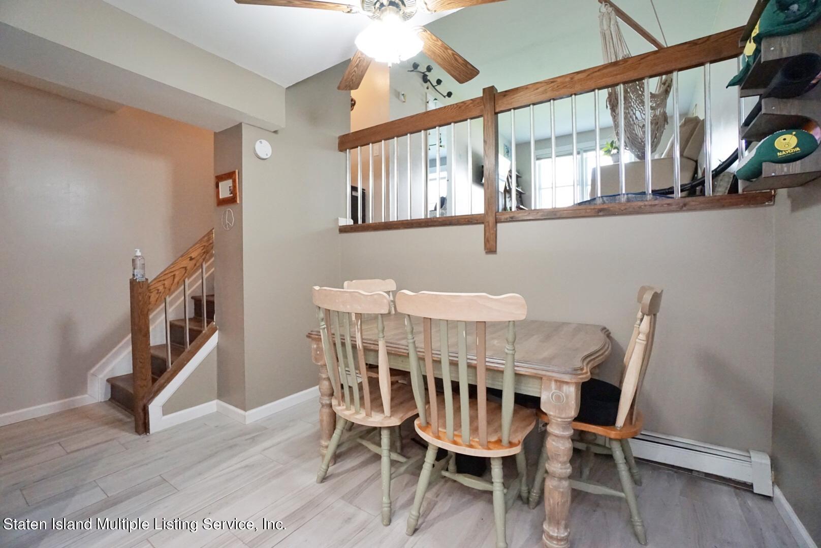 40 Racal Court, Unit B1 Staten Island, NY 10314 - Photo 5 of 16 a view of a dining room with furniture and a chandelier